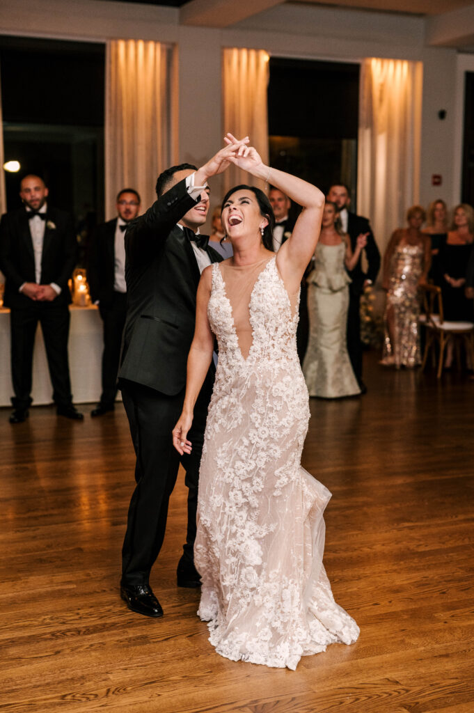 groom twirling bride during their first dance at september wedding