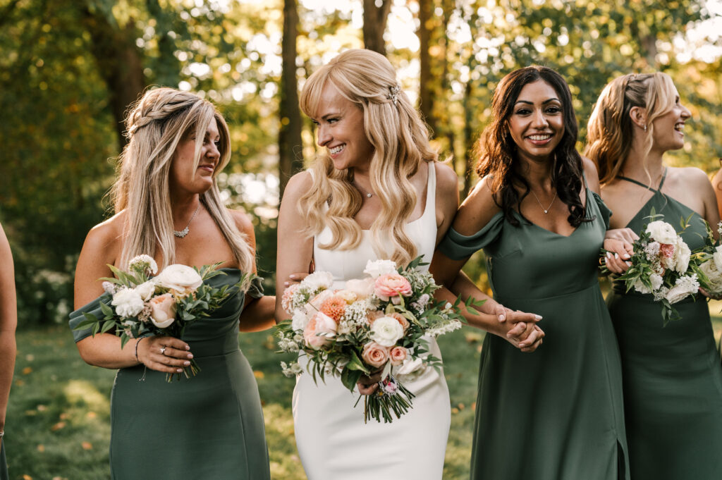 bride laughing with her bridal party during photos for nj september wedding