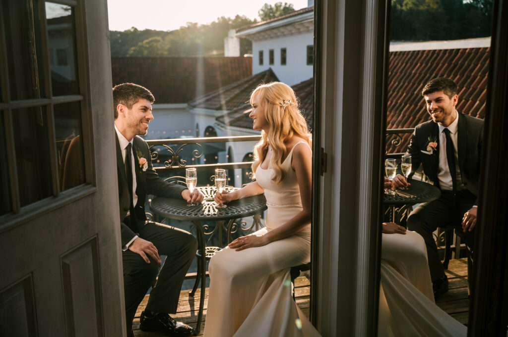 bride and groom sharing champagne with sun shining in background during fall wedding in nj