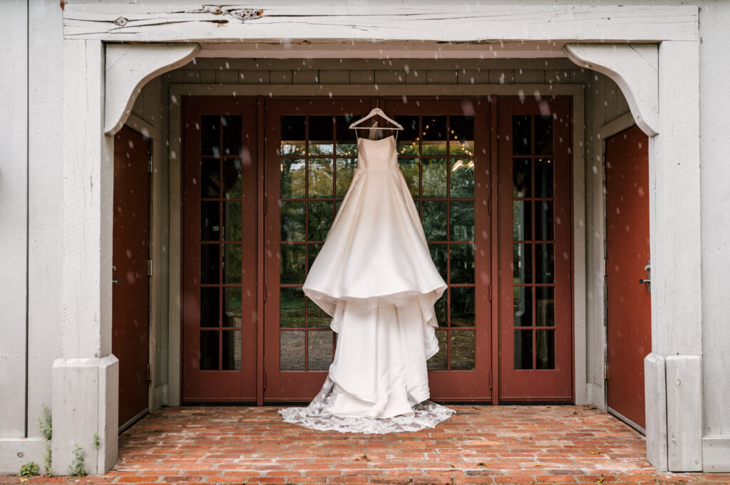 photo of bride's wedding dress hanging off one of the historic buildings at Waterloo Village in NJ