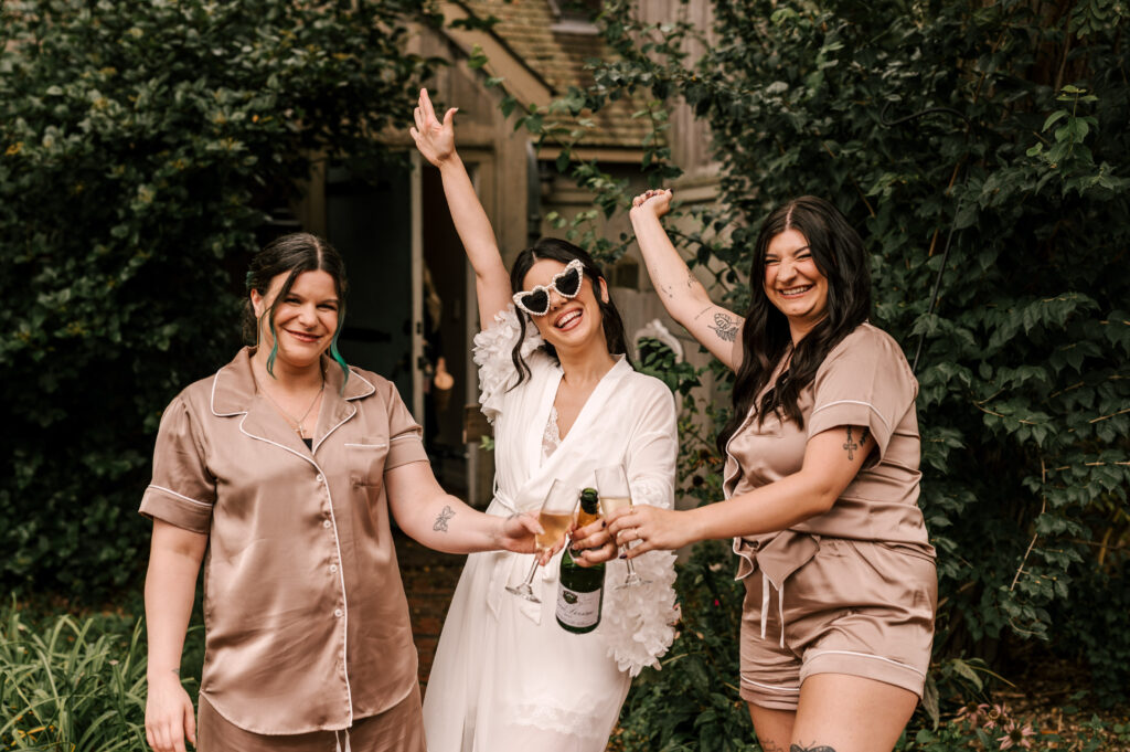 bride and bridal party popping champagne on wedding morning!