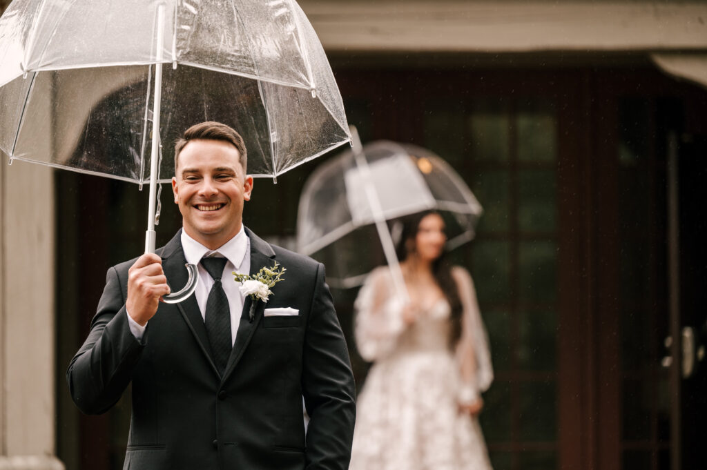 groom smiling waiting for bride to show up for first look at waterloo village