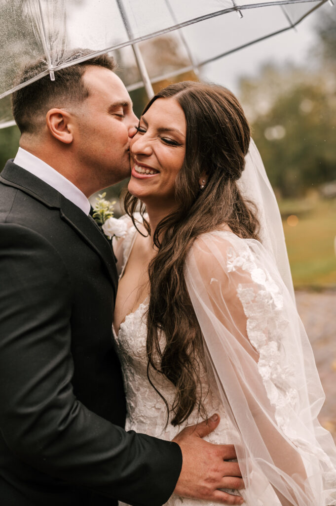 close up photo of groom kissing bride's cheek during photos at their waterloo village nj wedding