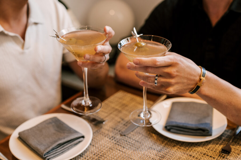 close up of two martini glasses with drinks made during engagement session in new jersey