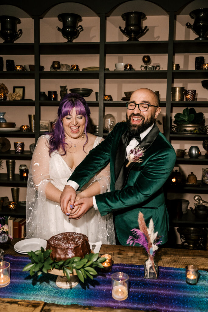 bride and groom cutting their cake with celestial-inspired table decor at their april new york wedding
