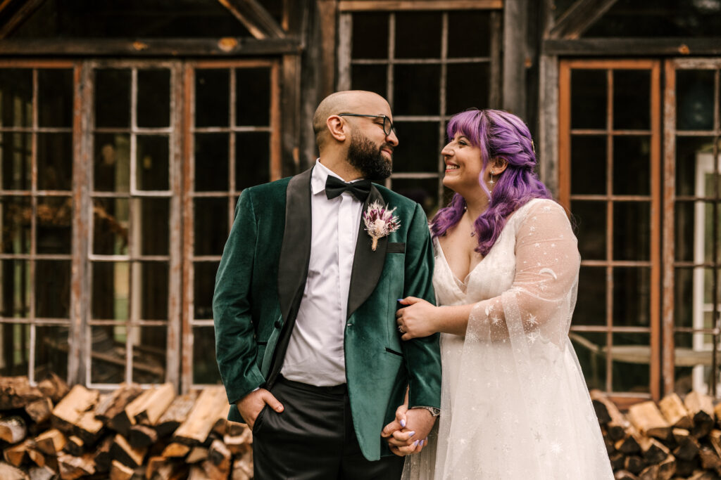 bride and groom smiling at one another during first look at april wedding