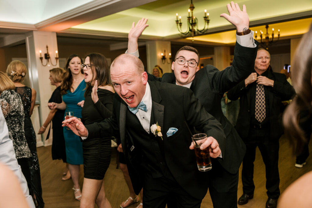 guests dancing during the reception at rock island lake club spring wedding in new jersey