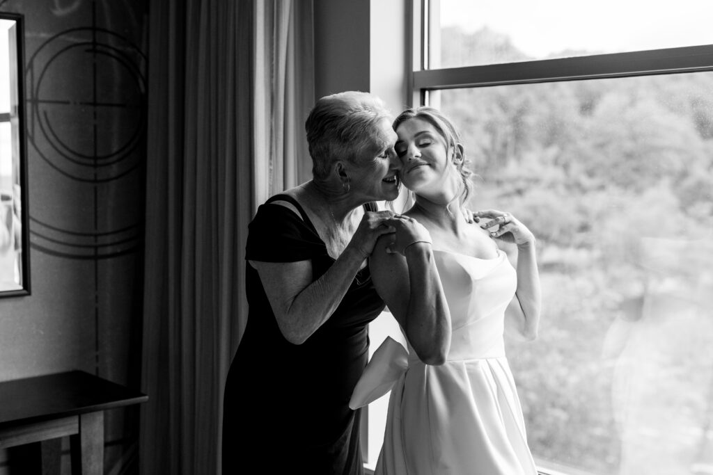 black and white photo of bride and her mother while she gets ready for her nj may wedding