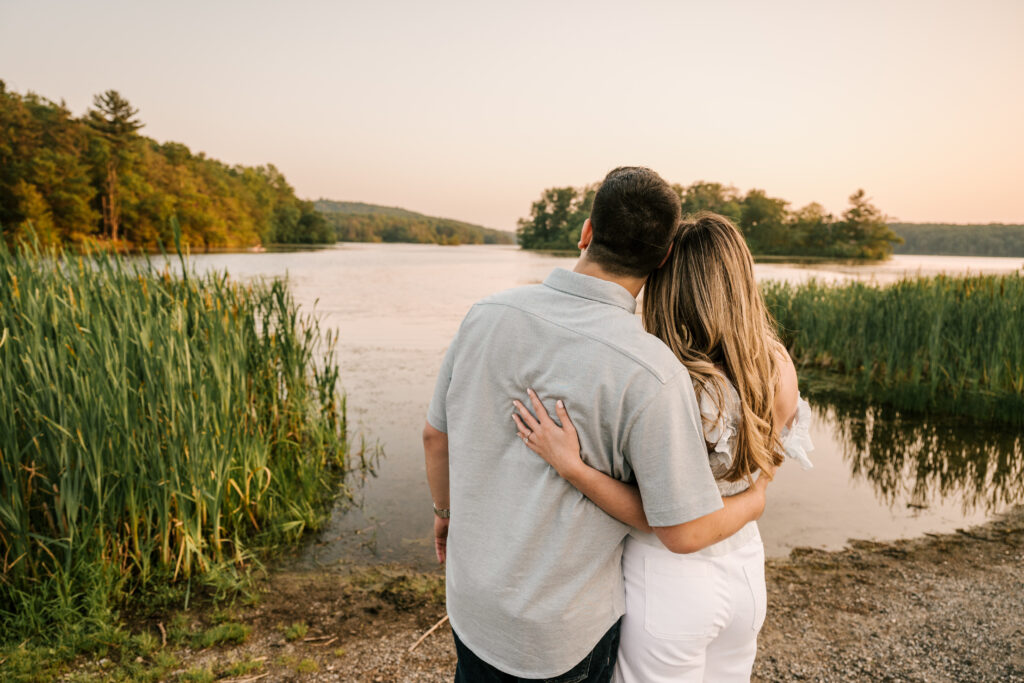 couple looking out at water at Wawayanda State Park during their June engagement session