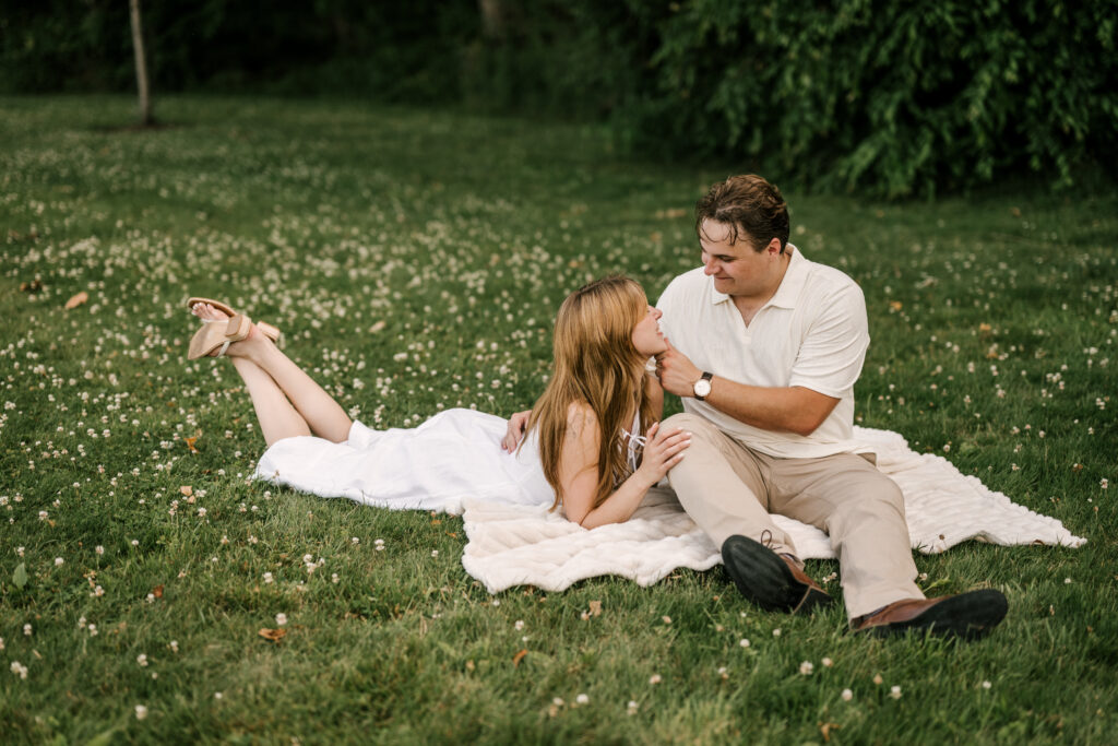 seated couple on a blanket for natirar engagement session