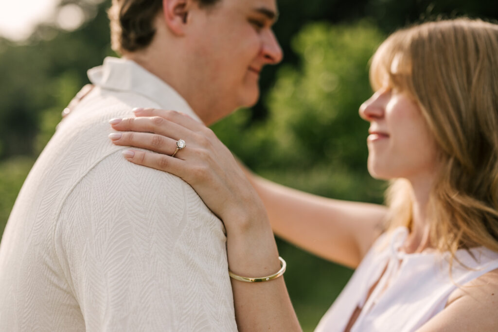 Close up of engagement ring during couple's engagement session